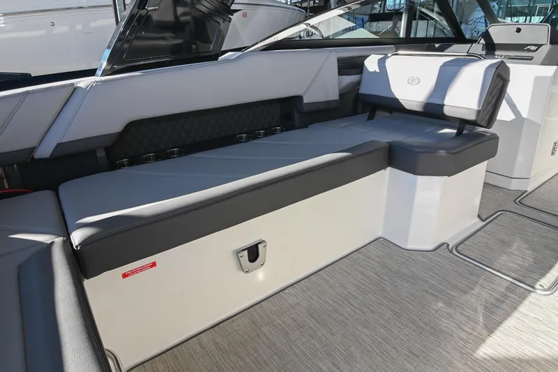 Slide: The Image of 2024 Cobalt R8 boat interior with wooden table and cup holders. - 20