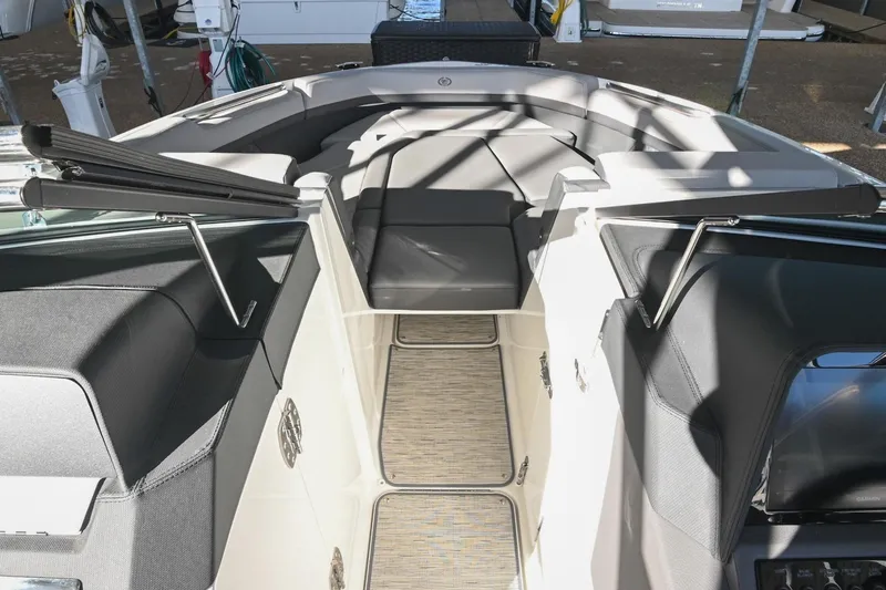 Slide: The Image of 2024 Cobalt R8 boat with speakers and canopy in a marina storage facility. - 37