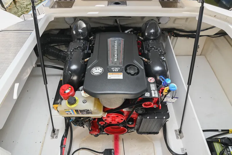 Slide: The Image of 2024 Cobalt R8 boat engine compartment with open hatch, dockside view. - 46