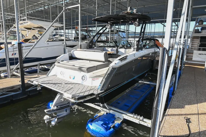 Slide: The Image of 2024 Cobalt R8 boat docked in a marina, showcasing sleek design and modern features. - 5