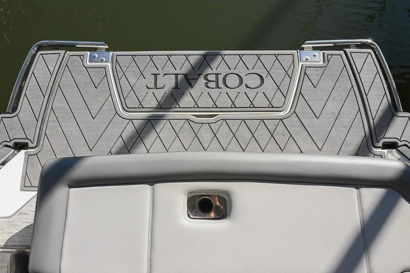 Slide: The Image of 2024 Cobalt R8 boat interior with sleek seating and modern design in a marina setting. - 9