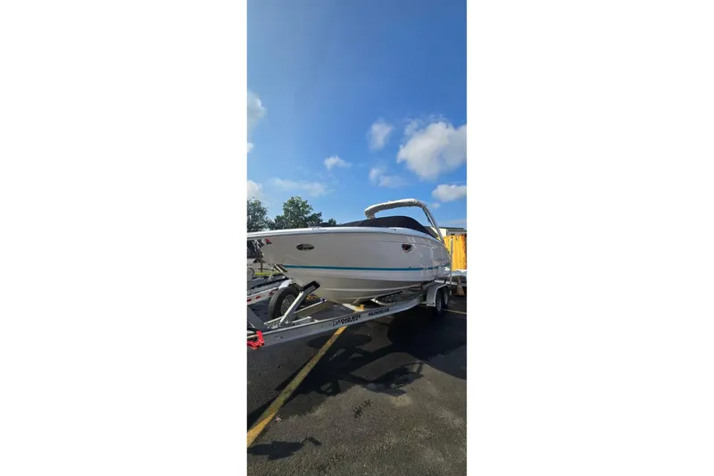 The Image of 2020 Regal LS6 boat on trailer, covered, with blue and white design. - 0