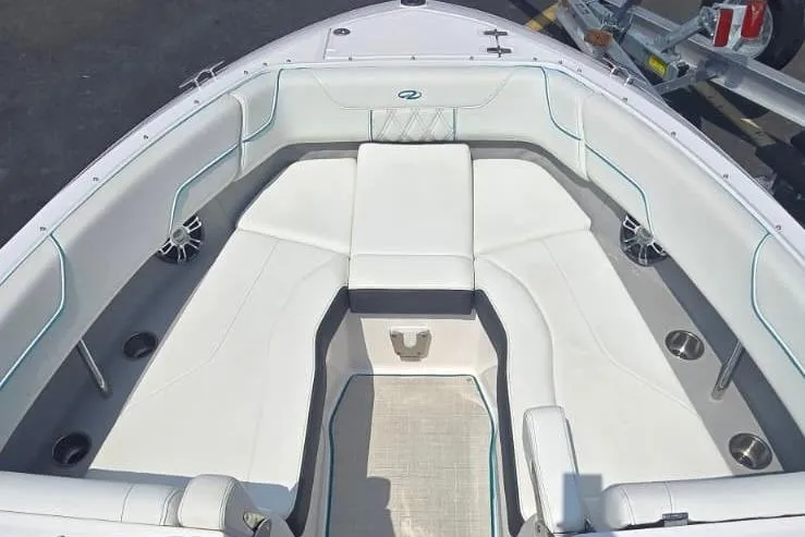 Slide: The Image of 2020 Regal LS6 boat interior with white cushioned seating and cup holders. - 6