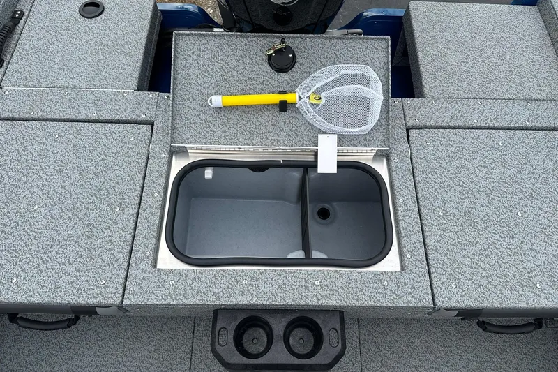 Slide: The Image of 2026 Lund 1675 Adventure Sport boat deck with storage compartments and fishing net. - 10