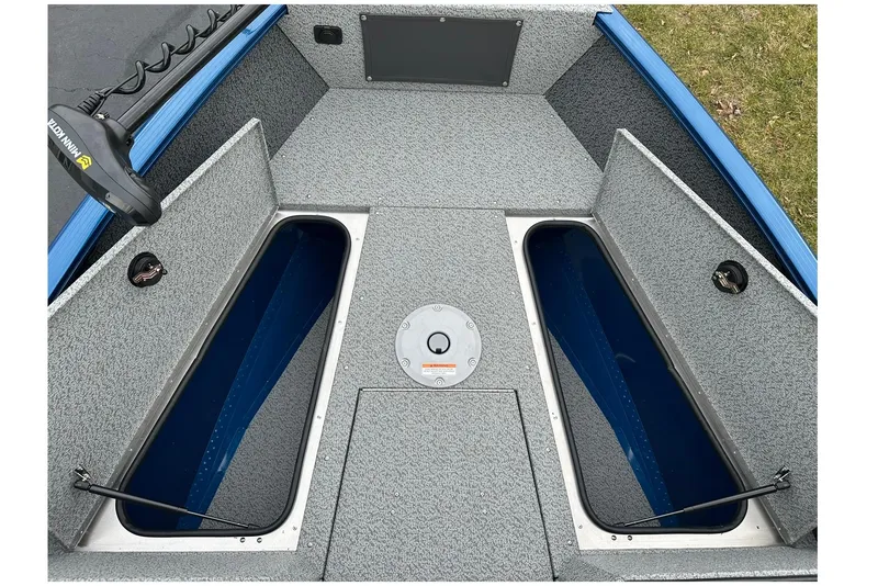 Slide: The Image of 2026 Lund 1675 Adventure Sport boat interior with open storage compartments. - 12