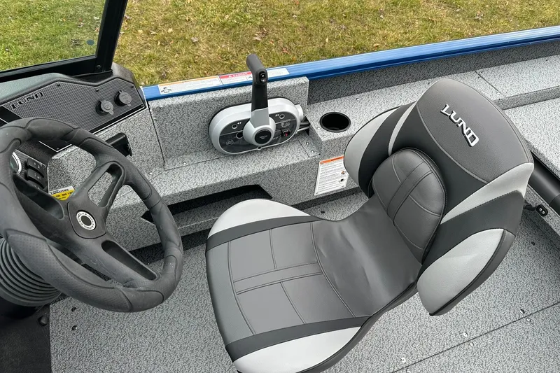 Slide: The Image of 2026 Lund 1675 Adventure Sport boat interior with steering wheel and branded seat. - 14