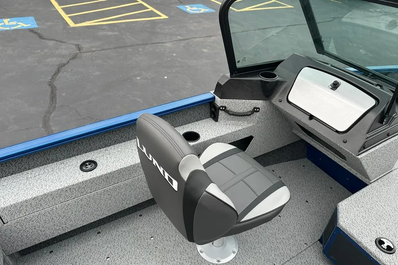 Slide: The Image of 2026 Lund 1675 Adventure Sport boat interior with seating and dashboard. - 15