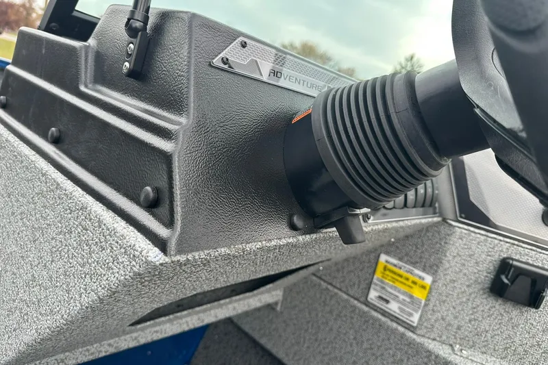 Slide: The Image of 2026 Lund 1675 Adventure Sport boat dashboard with steering wheel detail. - 19