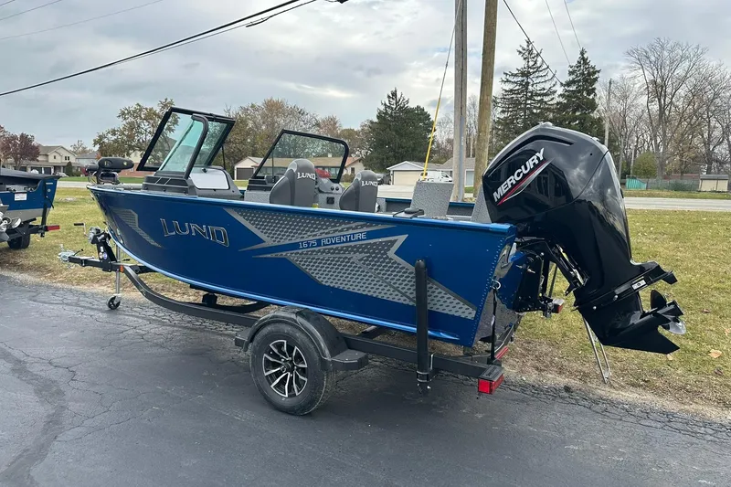 Slide: The Image of 2026 Lund 1675 Adventure Sport boat with Mercury outboard motor on trailer. - 2