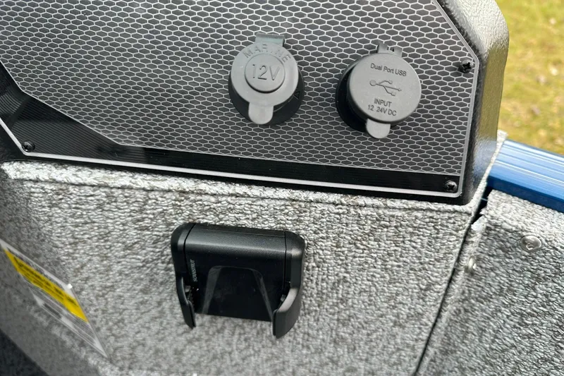 Slide: The Image of 2026 Lund 1675 Adventure Sport dashboard with 12V and dual USB ports. - 21