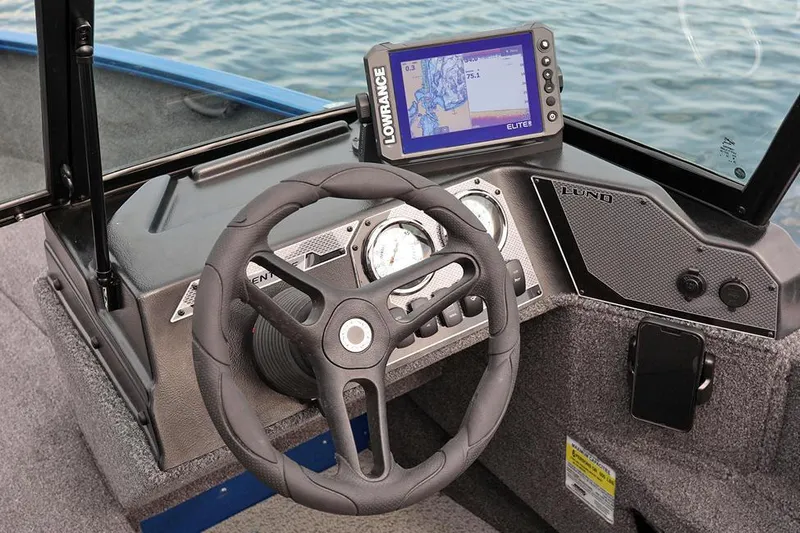 Slide: The Image of Manufacturer Provided Image: 2025 Lund 1675 Adventure Sport boat dashboard with steering wheel and navigation system. - 26