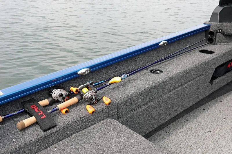 Slide: The Image of 2026 Lund 1675 Adventure Sport boat interior with fishing rods on deck. - 29