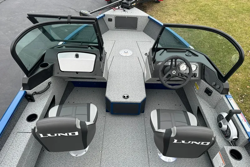 Slide: The Image of 2026 Lund 1675 Adventure Sport boat interior with dual seats and steering console. - 5
