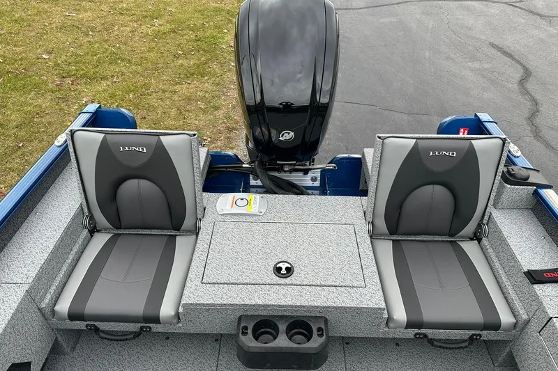 Slide: The Image of 2026 Lund 1675 Adventure Sport boat interior with dual seats and motor. - 8