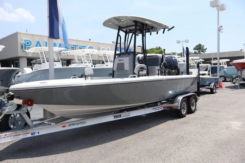 The Image of 2025 Pathfinder 2200 TRS boat on trailer at dealership, showcasing sleek design. - 0