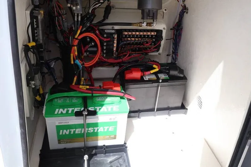 Slide: The Image of Electrical compartment of 2025 Pathfinder 2200 TRS with batteries and wiring. - 12