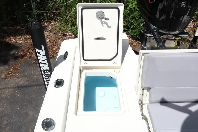 Slide: The Image of 2025 Pathfinder 2200 TRS boat with open storage compartment and seating area. - 19