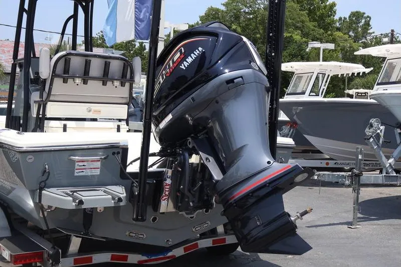 Slide: The Image of 2025 Pathfinder 2200 TRS boat with Yamaha outboard motor displayed outdoors. - 23