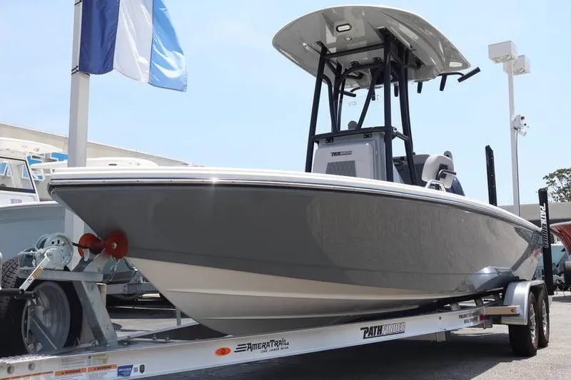 Slide: The Image of 2025 Pathfinder 2200 TRS boat on trailer, displayed outdoors under clear sky. - 24