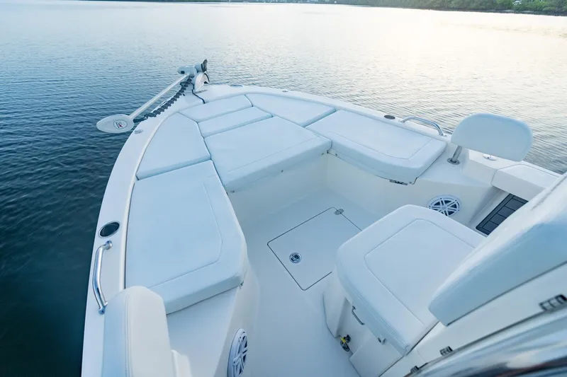 Slide: The Image of Manufacturer Provided Image: 2025 Pathfinder 2200 TRS boat interior on calm water, showcasing seating and storage. - 28