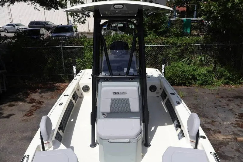 Slide: The Image of 2025 Pathfinder 2200 TRS boat with T-top and seating, parked outdoors. - 3