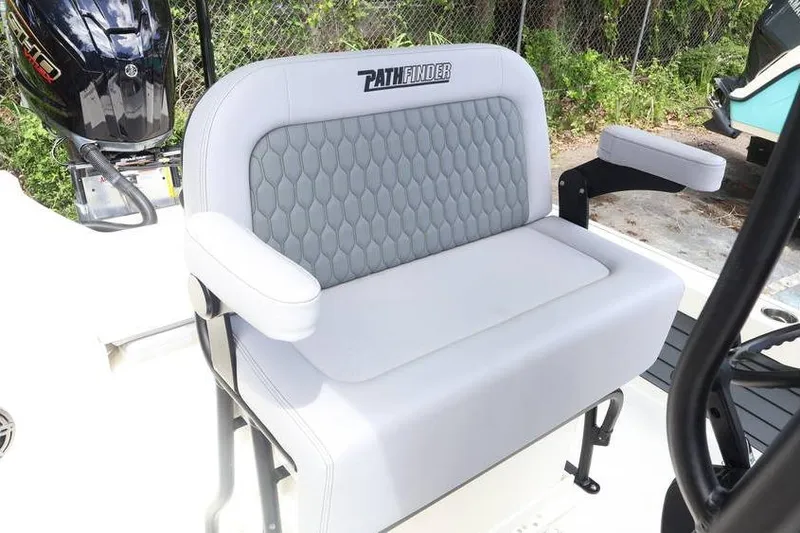 Slide: The Image of 2025 Pathfinder 2200 TRS boat seat with gray cushioning and armrests. - 4