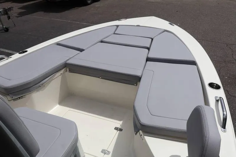 Slide: The Image of 2025 Pathfinder 2200 TRS boat with spacious gray cushioned seating area. - 7