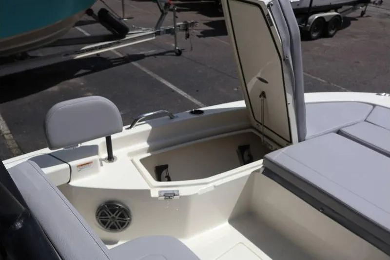Slide: The Image of 2025 Pathfinder 2200 TRS boat interior with open storage compartment and seating. - 9