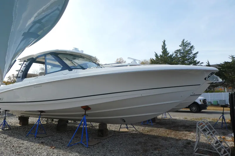 The Image of 2026 Boston Whaler 380 Realm boat on stands, side view, outdoors. - 0