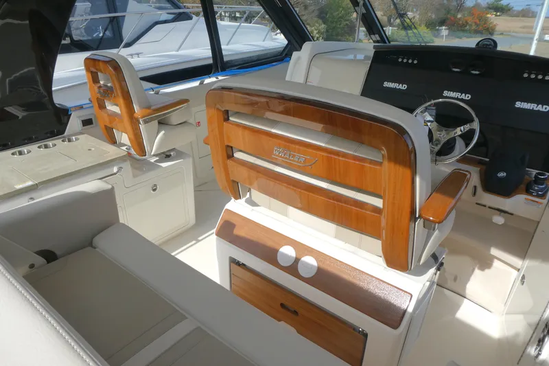 Slide: The Image of 2026 Boston Whaler 380 Realm interior with luxurious seating and advanced navigation systems. - 14