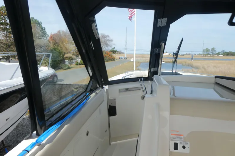 Slide: The Image of 2026 Boston Whaler 380 Realm interior view with open windows and scenic background. - 20