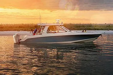 Slide: The Image of Manufacturer Provided Image: 2026 Boston Whaler 380 Realm boat on water at sunset, showcasing sleek design and luxury. - 23