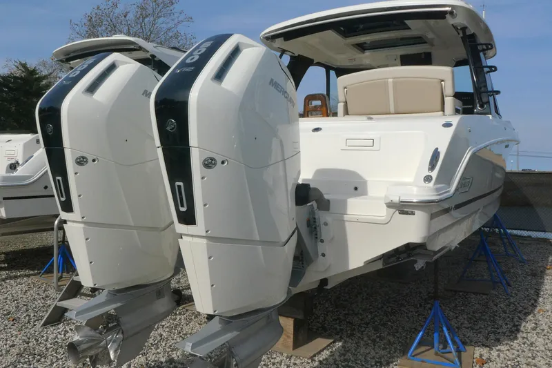 Slide: The Image of 2026 Boston Whaler 380 Realm with dual outboard engines on display. - 3