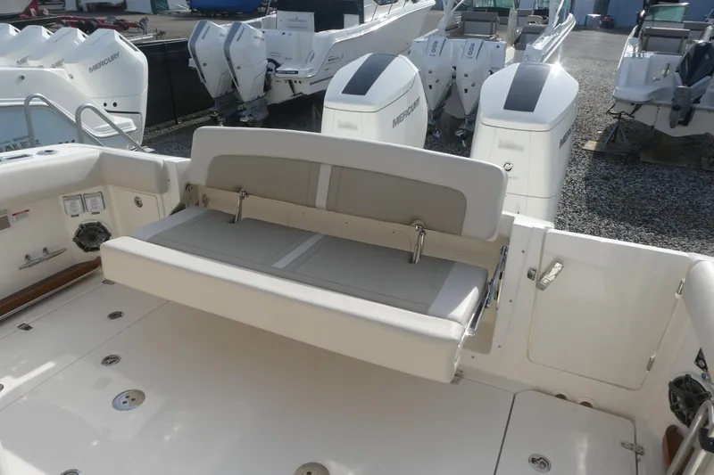 Slide: The Image of 2026 Boston Whaler 380 Realm boat interior with foldable seating and Mercury engines. - 6