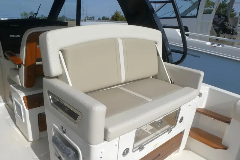 Slide: The Image of 2026 Boston Whaler 380 Realm interior seating with beige cushions and modern design. - 7