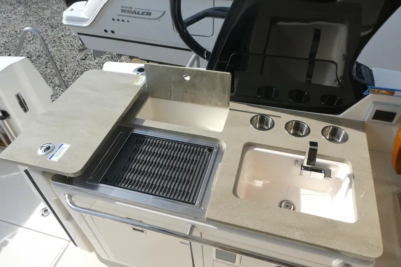 Slide: The Image of Boston Whaler 380 Realm 2026 boat kitchen with grill and sink setup. - 9