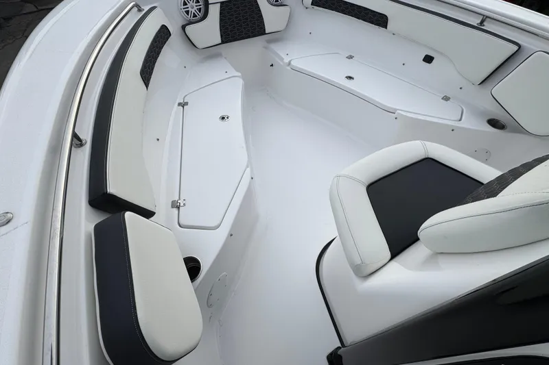 Slide: The Image of 2026 Tidewater 220 LXF boat interior with cushioned seating and storage compartments. - 11