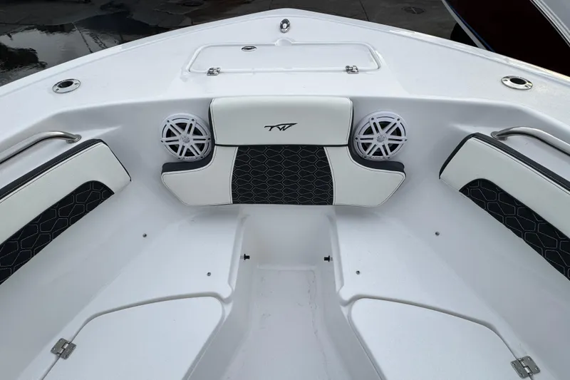 Slide: The Image of 2026 Tidewater 220 LXF boat interior with cushioned seating and speakers. - 12