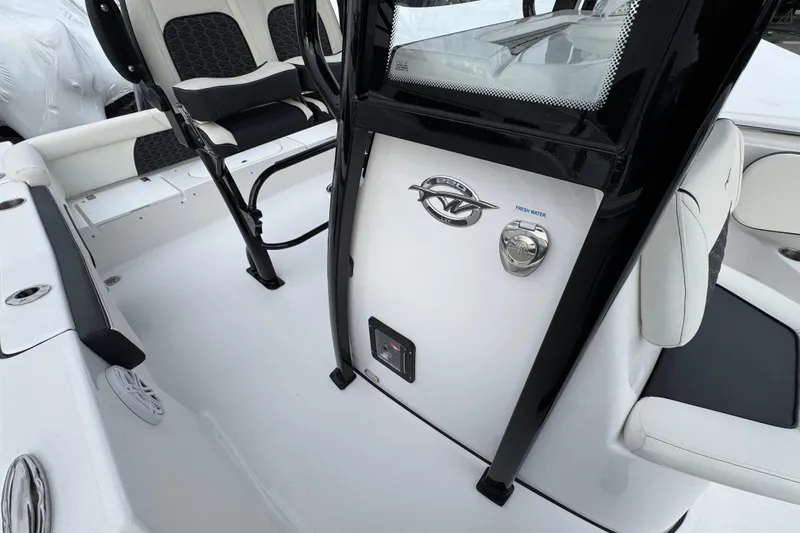 Slide: The Image of 2026 Tidewater 220 LXF boat interior with seating and console details. - 15
