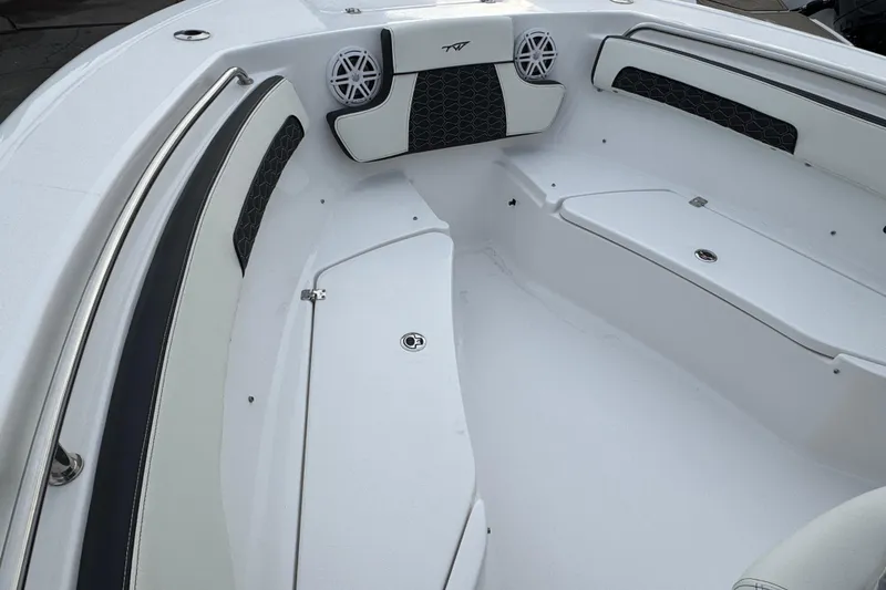 Slide: The Image of 2026 Tidewater 220 LXF boat interior with cushioned seating and speakers. - 19