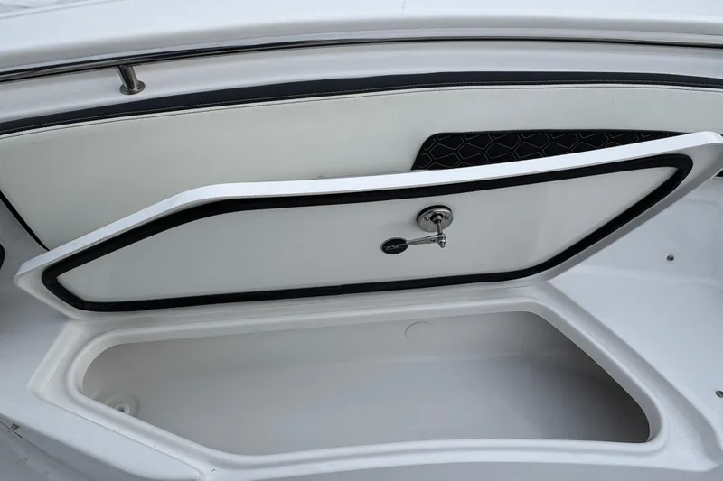 Slide: The Image of Open storage compartment on 2026 Tidewater 220 LXF boat, featuring sleek design and secure latch. - 21