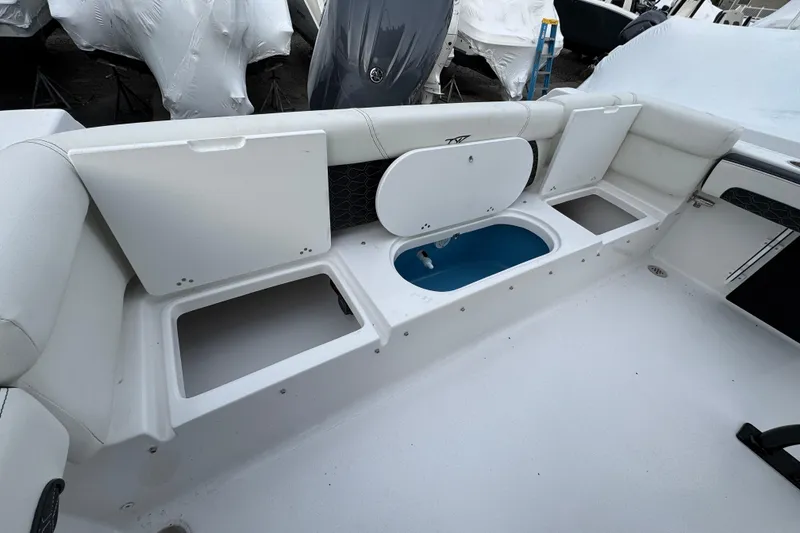Slide: The Image of 2026 Tidewater 220 LXF boat interior with storage compartments and seating area. - 24