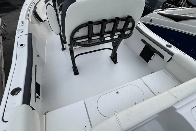 Slide: The Image of 2026 Tidewater 220 LXF boat interior with seating and rod holders. - 3