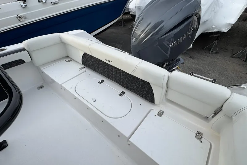 Slide: The Image of 2026 Tidewater 220 LXF boat interior with Yamaha engine, featuring white seating and storage compartments. - 4
