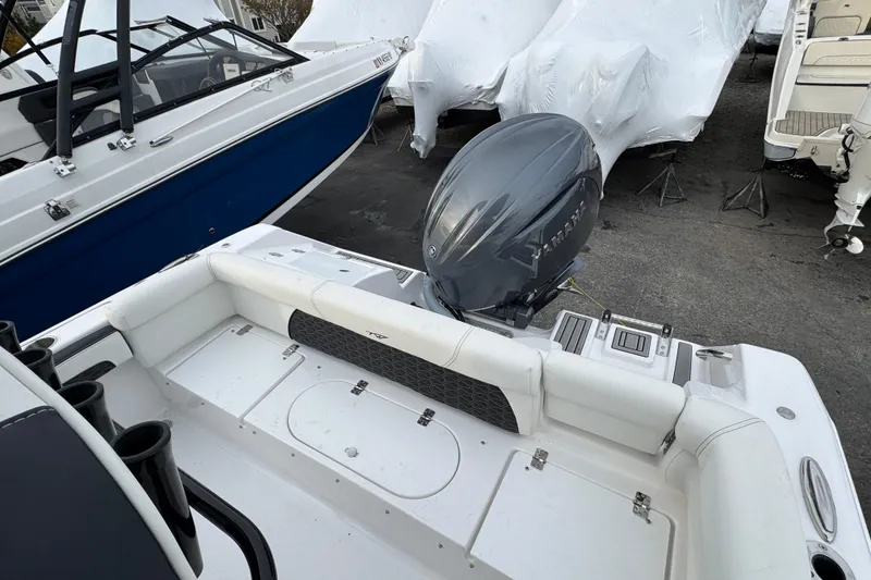 Slide: The Image of 2026 Tidewater 220 LXF boat with Yamaha outboard motor, docked alongside other boats. - 5