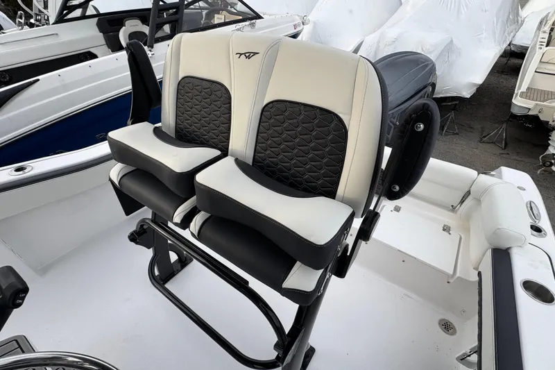 Slide: The Image of Dual captain's chairs on 2026 Tidewater 220 LXF boat, featuring sleek black and white design. - 6
