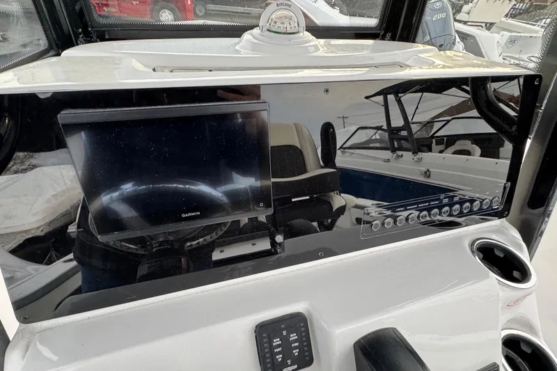 Slide: The Image of 2026 Tidewater 220 LXF boat dashboard with Garmin display and control panel. - 7