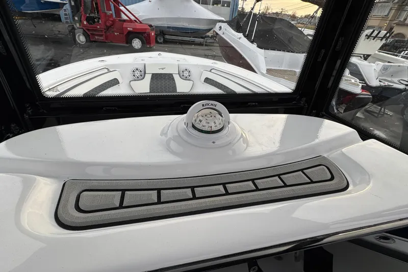 Slide: The Image of 2026 Tidewater 220 LXF boat dashboard with compass and control panel. - 8