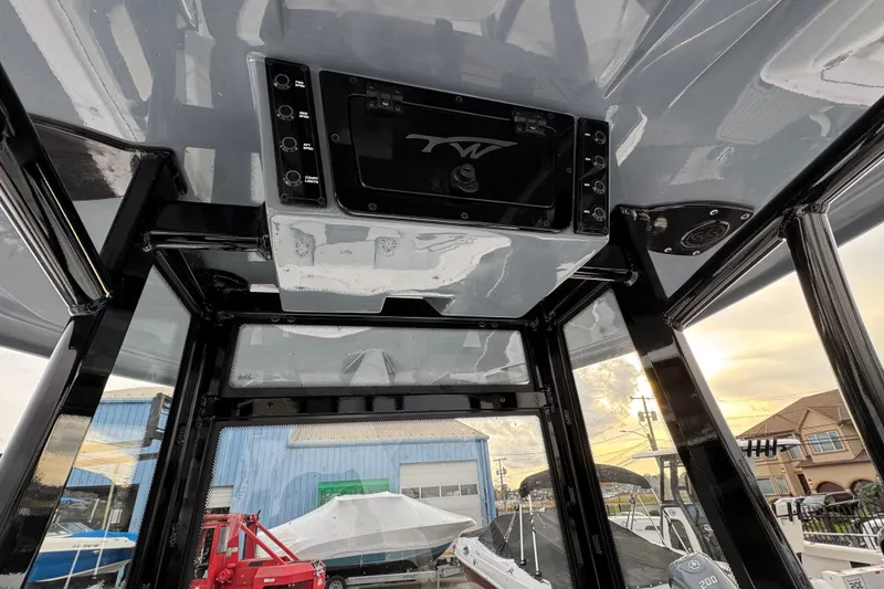 Slide: The Image of 2026 Tidewater 220 LXF boat interior with control panel and overhead view. - 9