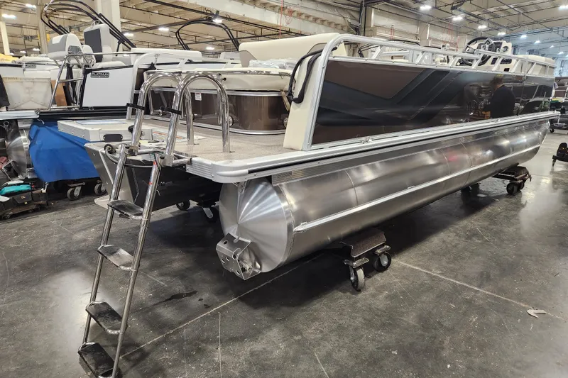 Slide: The Image of 2026 Avalon Venture Versatile Rear Bench pontoon boat in a showroom setting. - 13